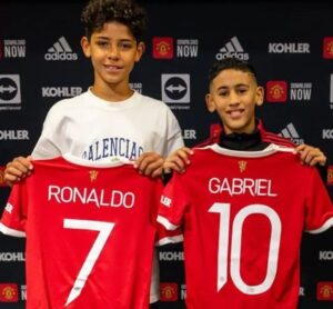 Cristiano Ronaldo Jr. is following into his father's footsteps as the Portuguese star's eldest son has officially joined Manchester United's academy at the age of 11.  Ronaldo's partner Georgina Rodriguez took to Instagram to publish a picture of Cristiano Ronaldo Jr. holding a Manchester United shirt featuring his father's No.7 at the back.  "Pursuing our dreams together," wrote Georgina. "Mum loves you."  Cristiano's son was presented by the club along with Gabriel, another talented youngster who already has more than 30,000 followers on Instagram.  A few days ago, the Portugal international uploaded some photos of him training with his son, who was wearing a Manchester United training top.  "Present and future," read the caption.  Back in 2020, Ronaldo was uncertain on whether his son could pursue a career in football due to his nutritional preferences at the age of 10.  "We'll see if my son will become a great footballer, he's not there yet," Cristiano said at the Global Soccer Awards ceremony.  "Sometimes he drinks Coca-Cola and Fanta and eats crisps, and he knows I don't like it.  "Sometimes I tell my son to take a dip in cold water to recover after a run on the treadmill and he says 'Dad, it's so cold there'. It's normal, he's 10 years old."