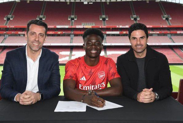 Bukayo Saka pen a new long-term contract to commit his future at Arsenal.

The England young star Bukayo Saka has agreed a deal worth at least £200,000 a week, which could rise to £300,000 a week with bonuses, and reflects his status as one of the best players in the Premier League.

Gunners have long since made a major breakthrough with regards to talks over the 21-year-old's future as an agreement in principle has been in place since February over a new long-term deal that will keep him at the club for the foreseaable future.

And now it can be revealed that Saka has been rewarded for hard work on the pitch With 13 goals and 11 assists to his name across all competitions so far this season, there's no denying that the England international can be a key player for the Gunners for many years to come, so naturally, supporters will be delighted to hear that he has officially ended speculation with regard to a move to Liverpool or Manchester City.

Mikel Arteta says tying down the youngster is key to the club’s continued progress.

He said: “It’s great for the club that Bukayo has extended his contract. Retaining our best young talents is key to our continued progress and Bukayo represents such an important part of our squad now and for the future.

“As well as being a fantastic talent, Bukayo is a special person — he’s loved by us all and he is a credit to himself and his family for the hard work and commitment they have all made to get to this level today.

“Together with our supporters, we’re so looking forward to enjoying Bukayo’s continued development with us in the years to come.”

Saka has been at Arsenal since he was eight and played a key role in the title push this season, scoring 14 goals and contributing 11 assists in all competitions.

The England international was due to be out of contract at the end of next season and Manchester City and a host of top European clubs were monitoring his situation. But it was always his desire to sign a new contract at a club he considers his home.

“I really feel the love from my team-mates, my coaches and the fans as well,” Saka said this season. “I really feel loved here.”

Securing Saka is a major boost to Arsenal in the long term, while it will also lift supporters ahead of Sunday’s final game of the season, at home to Wolves.